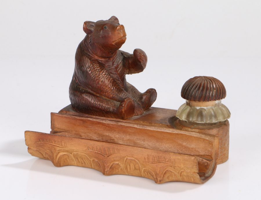 Black Forest novelty inkwell, modelled as a seated bear with paw raised, the clear glass inkwell