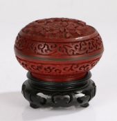 Chinese cinnabar lacquer box and cover, the foliate carved lid opening to reveal a blue enamel