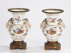 Pair of porcelain and metal mounted vases, the wide rim with a ball metal framed edge above a pair