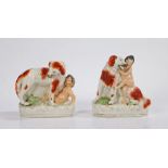 Pair of 19th Century Staffordshire porcelain figures, depicting a dog protecting a naked child