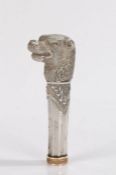 Late 19th Century white metal parasol handle, as a dog above a canted column and a yellow metal
