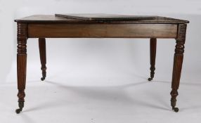 Regency mahogany extending dining table, raised on reeded tapering legs and castors, 114cm wide,