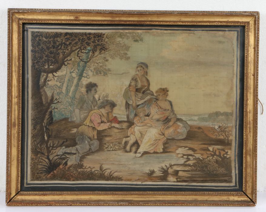19th Century woolwork picture depicting three ladies, a man and a child resting on a hillock in