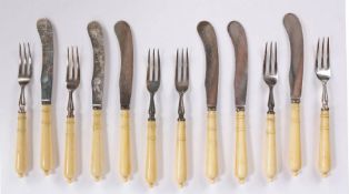Victorian twelve piece cutlery set, with turned ivory handles and steel three pronged forks and