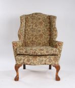 George III style wingback armchair, the floral upholstery with a wide back and seta above cabriole