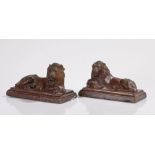 Pair of late 18th Century salt glaze lion, both in a reclined position with paws crossed above a