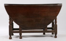 18th Century oak gateleg table, the oval top on bobbin turned legs and flattened stretchers, 124cm