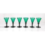 Set of six 19th Century green glass flutes, with trumpet tops above ring stems and a wide foot and