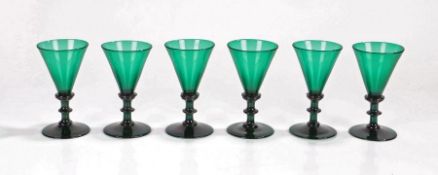 Set of six 19th Century green glass flutes, with trumpet tops above ring stems and a wide foot and