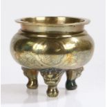 Chinese brass censer, the rounded body with leaf etched decoration above dragon mask feet, 18cm