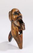 19th Century fruitwood treen nutcracker, carved as a bearded man with a pointed hat and glass