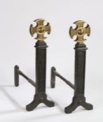 Pair of Gothic revival fire dogs, with brass crosses to the top above rectangular stems and