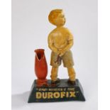 Advertising shop display figure, "DAD- WHERE'S THE DUROFIX", depicting a young boy with his arms