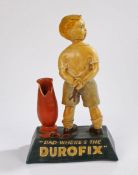 Advertising shop display figure, "DAD- WHERE'S THE DUROFIX", depicting a young boy with his arms