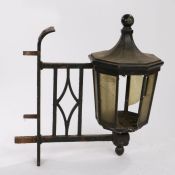 Cast iron wall mounted gas lantern, the octagonal tapering lantern with glass panes, on a pierced