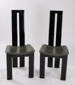 Pair of japanned dining chairs, the curved double splat backs above grey leatherette dished seats