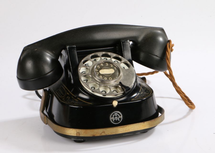 Bell Telephone company, FTTR, with a Bakelite receiver above the black and gilt decorated body