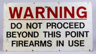 Enamel sign, "Warning do not proceed beyond this point firearms in use", 81cm x 45cm