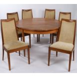 G-Plan teak circular extending dining table and six chairs, the table with central cantilever