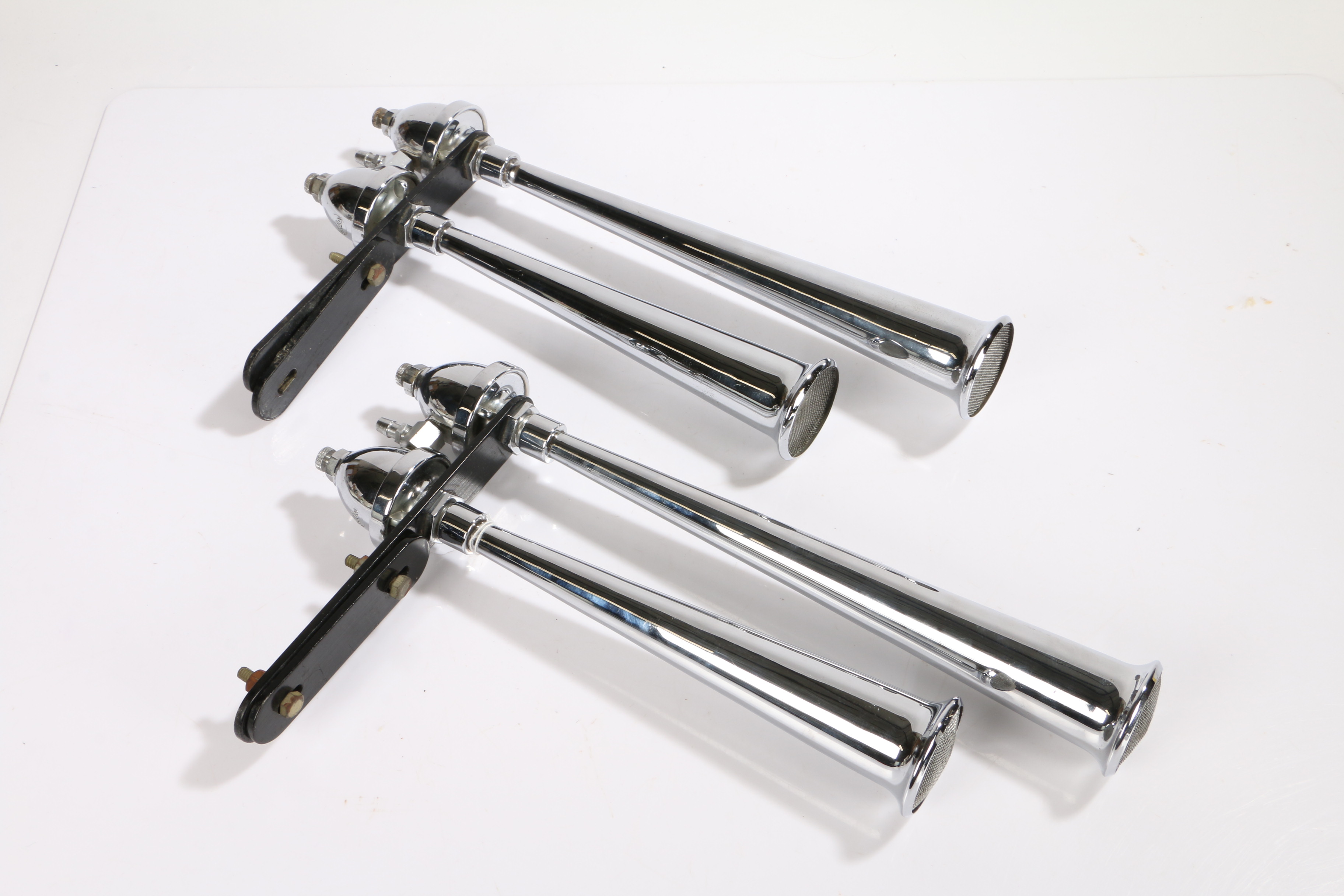Pair of Trico chrome twin air horns, with tapered horns with mesh ends, 42cm long