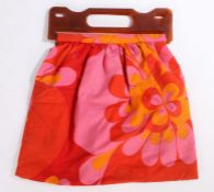 1960's plastic and fabric bag, the orange plastic handles above the bright red, orange and pink bag,
