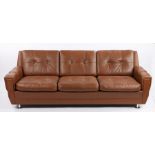 Skipper brown leather upholster three seat settee, with buttoned back and seat cushions, raised on