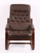 Mid 20th Century armchair, the brown buttoned leatherette back and seat flanked by padded arms, on