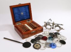 Cased set of opticians lenses, together with opticians glasses and further lenses, (qty)