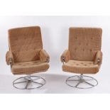 Pair of mid 20th century easy chairs, with buttoned backs, seats and arms, raised on tubular