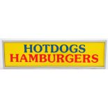 Yellow plastic panel inscribed "HOTDOGS HAMBURGERS" in blue and red, housed in an aluminium frame,