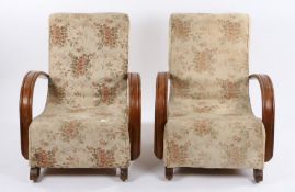 Pair of Art Deco armchairs, the foliate upholstered backs and seats flanked by curved arms, raised