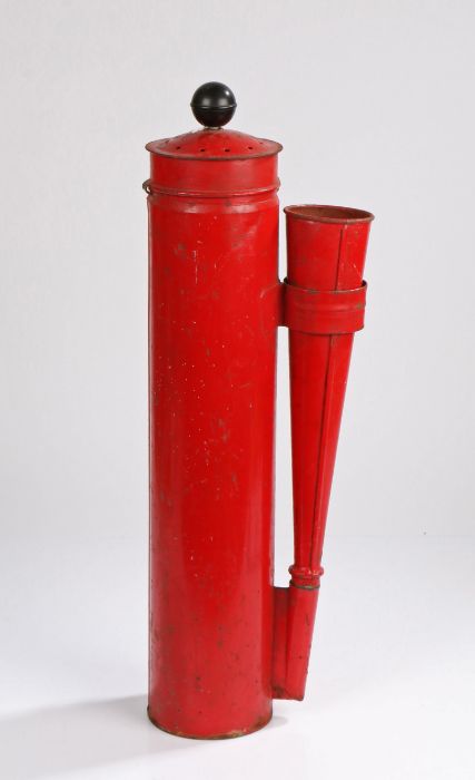 Red painted fire extinguisher, the ebonised pump handle above a cylindrical body flanked by a