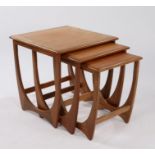 Nest of three G-Plan Astro teak occasional tables, the square tops raised on curved supports, the