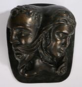 Black Isle Bronze sculpture depicting male and female masks, with foundry mark verso, 34cm wide,