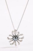 18 carat white gold black pearl and diamond set pendant necklace, the cabochon cut central pearl