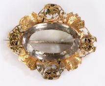 Victorian brooch, the yellow metal pierced and arch surrounding the central large facetted stone,