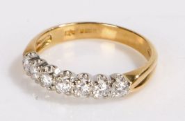 18 carat gold and diamond set ring, with a row of seven round diamonds to the head, 2.5 grams,