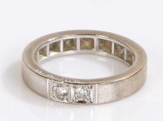 18 carat white gold ring set with two diamonds, the round cut diamonds set into the shank, 5.1