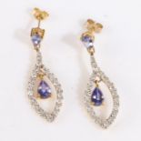 Pair of 18 carat gold tanzanite and diamond set earrings, the pear cut tanzanite above the diamond