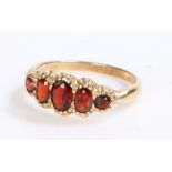 9 carat gold garnet set ring, with five oval garnets set to the shaped head, 2.2 grams, ring size