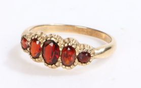 9 carat gold garnet set ring, with five oval garnets set to the shaped head, 2.2 grams, ring size