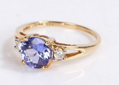 14 carat gold tanzanite and diamond set ring, the central round cut tanzanite with a diamond to