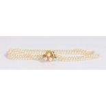 14 carat gold and pearl necklace, the gold clasp set with three pearls attached to the three