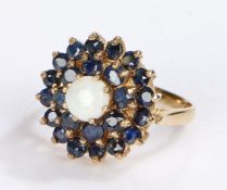 9 carat opal and sapphire set ring, the central opal with two rows of sapphires, 4.5 grams, ring
