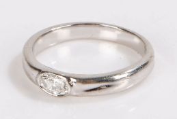 Diamond set ring, the oval diamond sunk to the centre of the white metal shank, 4 grams, ring size