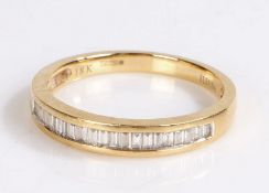 18 carat gold diamond set ring, with a row of baguette cut diamonds graduated into the head of the