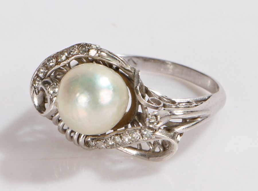 14 carat white gold pearl and diamond set ring, the raised pearl at 8mm in diameter above the