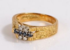 18 carat gold diamond and sapphire set ring, set with a row of four sapphires flanked by four