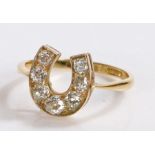 18 carat gold diamond set ring, in the form of a horse shoe set with seven round cut diamonds, 3.4