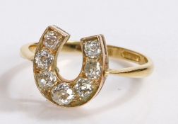 18 carat gold diamond set ring, in the form of a horse shoe set with seven round cut diamonds, 3.4